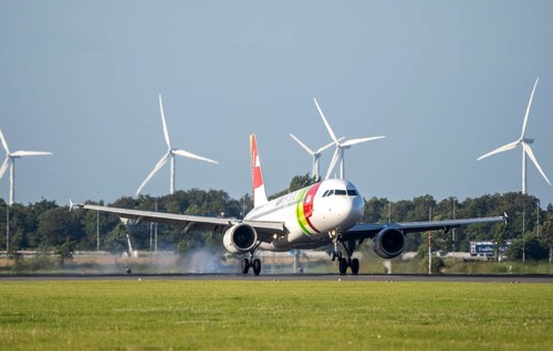 AirPortugal, aircraft landing at Amsterdam Schiphol Airport, Polderbaan, 18R/36L, wind farm in the