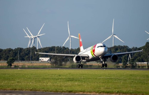 AirPortugal, aircraft landing at Amsterdam Schiphol Airport, Polderbaan, 18R/36L, wind farm in the
