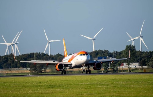 EasyJet, aircraft landing at Amsterdam Schiphol Airport, Polderbaan, 18R/36L, wind farm in the
