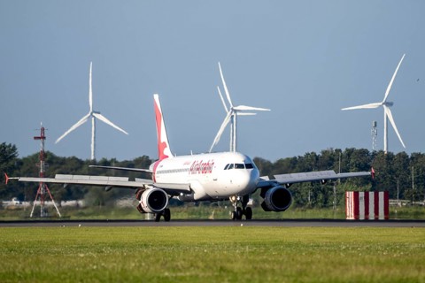 Airarabia aircraft landing at Amsterdam Schiphol Airport, Polderbaan, 18R/36L, wind farm in the