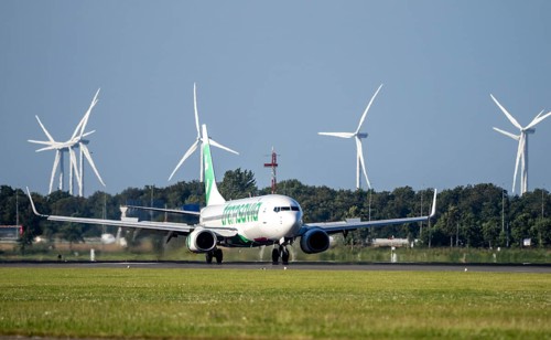 Transavia aircraft landing at Amsterdam Schiphol Airport, Polderbaan, 18R/36L, wind farm in the