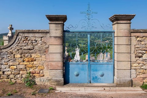 Cemetery wall with a blue entrance gate, Burgundy, France, Europe