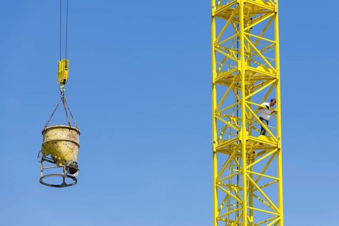 Construction crane with concrete bucket, concrete silo, crane bucket