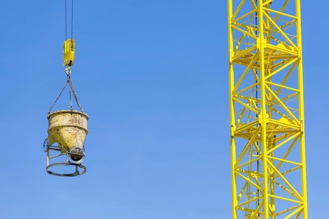 Construction crane with concrete bucket, concrete silo, crane bucket