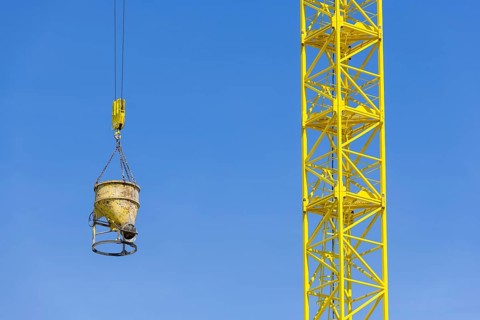 Construction crane with concrete bucket, concrete silo, crane bucket