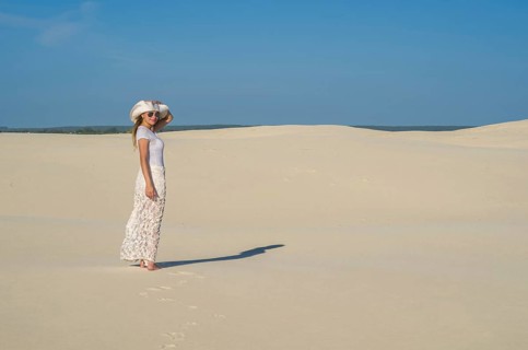 Young woman walking in the dunes, desert