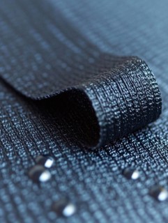Shiny black textured ribbon with small beads, AI generated