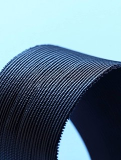 Close-up of a ribbed texture object against a blue background, AI generated