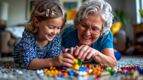 An elderly woman and her young granddaughter happily engaged in playing with colorful blocks