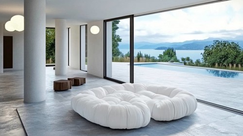 Luxurious modern interior featuring a large white sofa, floor-to-ceiling glass walls with a view of