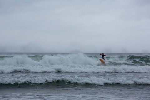 A surfer enjoying the waves on a windy day in the North-West. Strandhill, Sligo, Ireland, Europe
