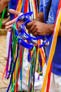 Tambourine player with his instrument decorated with colorful ribbons during a performance at a