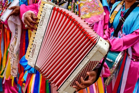 Accordionist playing his instrument during a religious festival in the streets of Belo Horizonte,