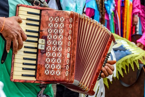 Accordionist playing during an important and traditional religious festival in the streets of Belo