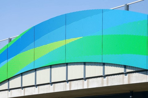 Colourfully painted motorway bridge with noise barrier over the river Este, Buxtehude, Altes Land,