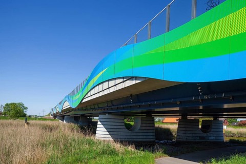Colourfully painted motorway bridge with noise barrier over the river Este, Buxtehude, Altes Land,