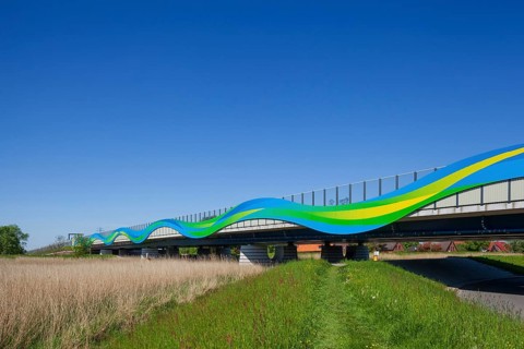 Colourfully painted motorway bridge with noise barrier over the river Este, Buxtehude, Altes Land,