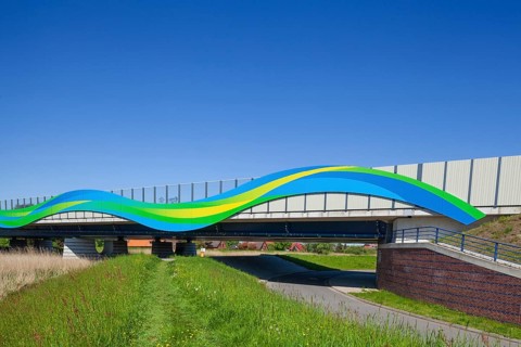 Colourfully painted motorway bridge with noise barrier over the river Este, Buxtehude, Altes Land,