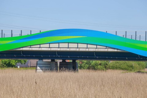 Colourfully painted motorway bridge with noise barrier over the river Este, Buxtehude, Altes Land,