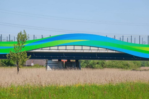 Colourfully painted motorway bridge with noise barrier over the river Este, Buxtehude, Altes Land,