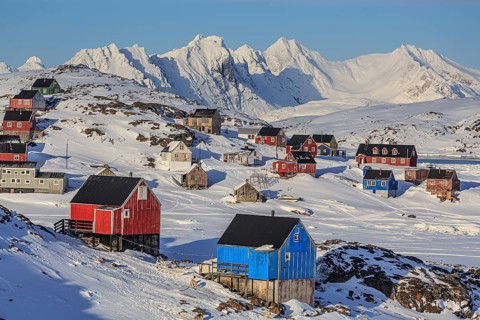 Typical Greenlandic houses in front of snowy mountains, Inuit settlement, winter, Arctic, Kulusuk,