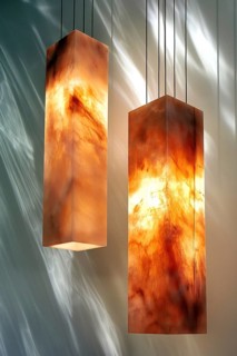 Vertical, rectangular marble hanging lamps casting a warm light, exhibiting artistic and modern