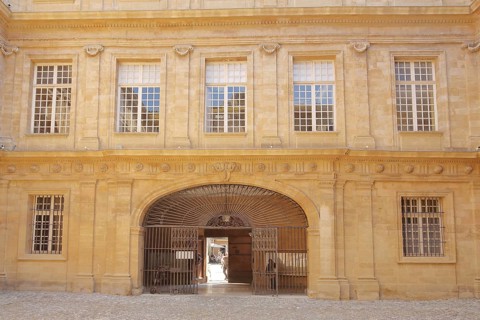 House facade with metal gate and window in the inner courtyard of the town hall, decorations,