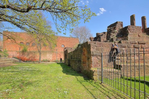 Casimir castle built in 1934 and imperial palace, child, climbing, bars, metal fence,