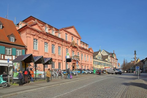 Historic royal court built in 1717 and bus stop with people, police building, main street,