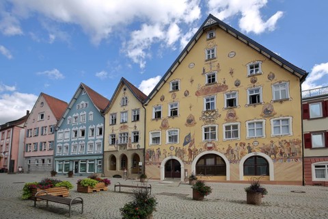 Historic half-timbered houses with town hall built in 1765 with murals and yellow guardhouse built