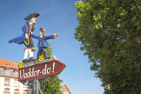 Sign with figures and inscription Vadder-do in Hessian dialect, father, son, look, show,