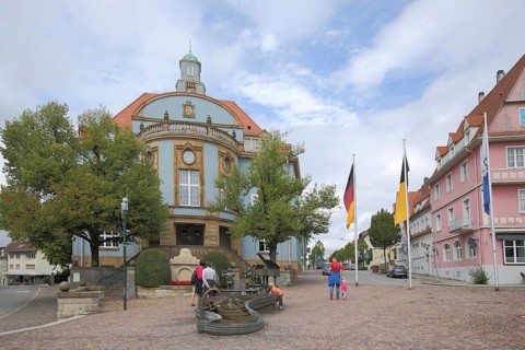 Blue town hall in Art Nouveau style with musicians' fountain, people, Donaueschingen, Southern
