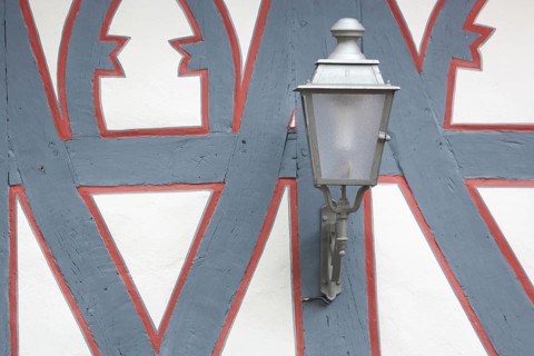 Street lamp on the wall of a half-timbered house, red, grey, frame, border, detail, decoration,
