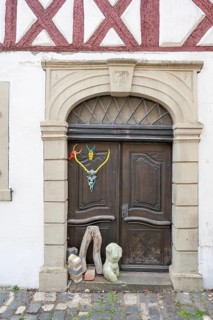 Art objects in front of a historic entrance gate, Mainbernheim, Lower Franconia, Bavaria, Germany,