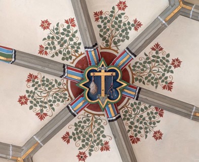 Cross of Jesus with the instruments of the scourge, keystone in the vault of the Cathedral of the
