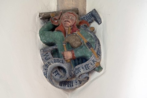 Fool figure with bagpipes, console stone in St Martin's Church, Plieningen, Baden-Württemberg,