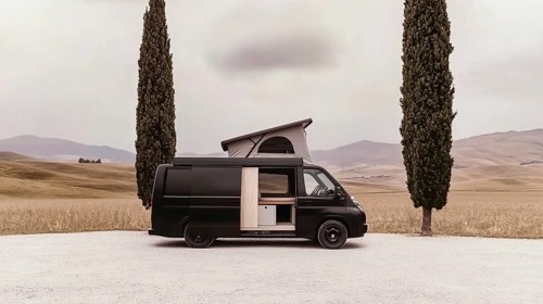 Black van in a rural setting surrounded by two tall trees, capturing a vibe of solitude, AI