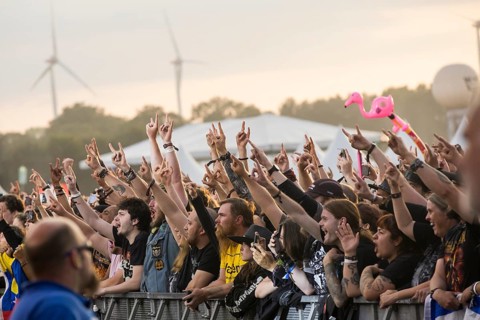 Festival-goers in the front row give the devil's salute at the Wacken Open Air in Wacken. The