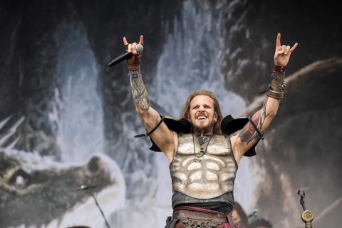 Captain Feuerschwanz, singer of the band Feuerschwanz, shows the metal salute at the Wacken Open