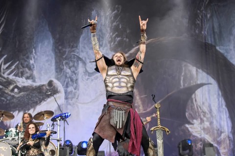 Captain Feuerschwanz, singer of the band Feuerschwanz, shows the metal salute at the Wacken Open