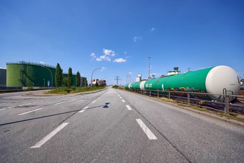Road with oil tanks and a railway line with tank wagons in the port of Hamburg, Free and Hanseatic