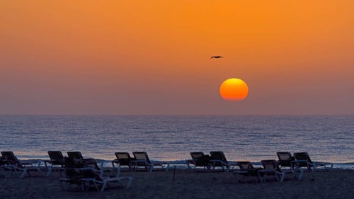 Destination Spain, swimming in the sea, travel, holidays, sunrise, sun loungers on the beach, sun