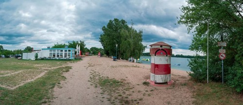 Old round red and white striped changing room from GDR times in the shape of a lighthouse on the