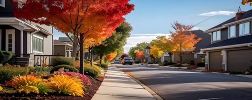 A serene suburban street featuring modern homes in autumn with colorful plants, AI generated