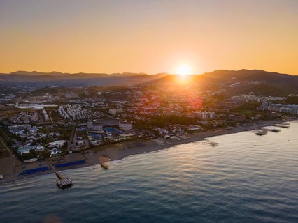 The sun rises behind the mountains of the Taurus Mountains on the Turkish Riviera. (Aerial view