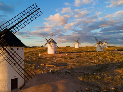 Several windmills in a rural landscape under a slightly cloudy evening sky, aerial view, windmills,