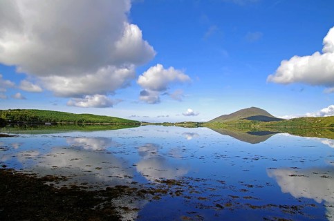 Calm lake with cloud reflections and mountain hills in the background, Letterfrack, Connemara