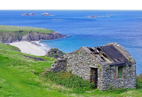 Stone ruins with grass cover on the coast with islands in the background, Blasket Islands, Dunmore