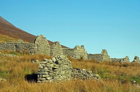 Stone ruins in a meadow under a clear sky, Achill Island, County Mayo, Ireland, Europe