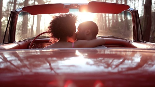 Couple sharing a tender kiss in a red convertible surrounded by woods at sunset, AI generated